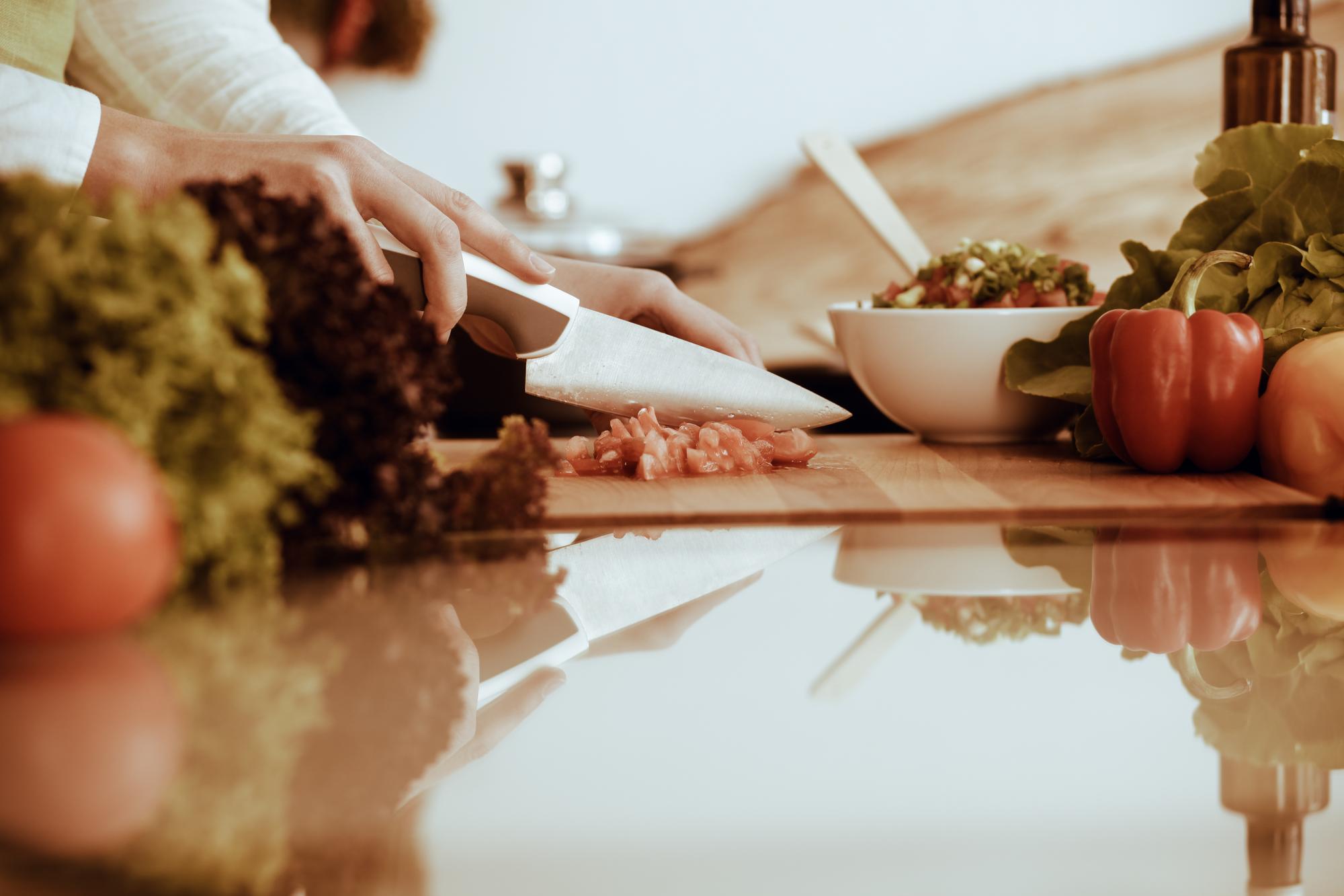 Chef teaching hands-on cooking at wooden table